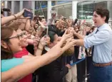  ??  ?? Canadian Prime Minister Justin Trudeau shakes hands in downtown Manila, Philippine­s, Monday.