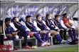  ?? ROBERT MICHAEL — ASSOCIATED PRESS ?? Aue’s reserve players sit on the bench with space between them and wearing masks during the 2nd Bundesliga match between FC Erzgebirge Aue and SV Sandhausen on Saturday.