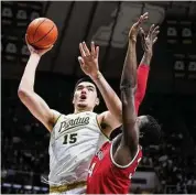  ?? Michael Conroy/Associated Press ?? Purdue center Zach Edey (15) shoots over Ohio State center Felix Okpara in the second half in West Lafayette, Ind., on Sunday. Purdue defeated Ohio State 82-55.
