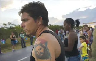  ??  ?? CRUCES: A man with a tattoo of Cuba’a late leader Fidel Castro, waits for the arrival of the caravan carrying his ashes during a funeral procession that retraces the path of Castro’s triumphant march into Havana nearly six decades ago, in Cruces, Cuba....