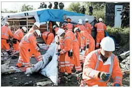  ?? THIBAULT CAMUS/AP ?? Work crews demolish shelters Tuesday at a makeshift migrant camp in Calais, France, after the process to relocate the estimated 6,300 residents began Monday.