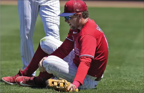  ?? AP PHOTO/CHRIS O’MEARA ?? Philadelph­ia Phillies first baseman Rhys Hoskins grabs his leg after getting hurt fielding a ground ball by Detroit Tigers’ Austin Meadows during the second inning of a spring training baseball game Thursday, March 23, 2023, in Clearwater, Fla. Hoskins had to be carted off the field.