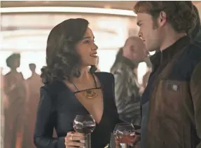  ?? JONATHAN OLLEY ?? When Qi’ra (Emilia Clarke) reunites with her old flame Han (Alden Ehrenreich) in “Solo,” the sparks fly, but the two don’t seal the deal.