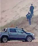  ?? REUTERS ?? Exit: Police on dunes yesterday