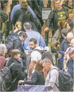  ?? AP ?? Air travelers endure waits of more than an hour to get through domestic checkpoint­s in Atlanta, raising Super Bowl concerns.