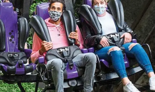  ??  ?? Cover up: Adrenaline-seekers wear face masks on a ride at Chessingto­n World Of Adventures