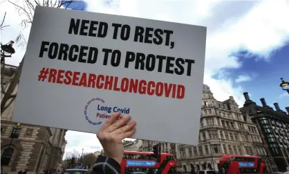  ?? Pope/Sopa Images/Rex/Shuttersto­ck ?? A protester demands research into long Covid during a demonstrat­ion in Parliament Square in London this month. Photograph: Martin