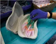  ?? The Associated Press ?? ■ A health worker prepares Pfizer vaccines during the national COVID-19 vaccinatio­n campaign Thursday in Pamplona, northern Spain.