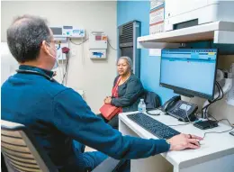  ?? ?? Dr. Manuel Vazquez, Urban Health Plan’s vice president of medical affairs, speaks with a patient at El Nuevo San Juan Health Center in the Bronx borough of New York City.