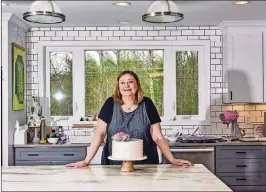  ?? TONY LUONG / THE NEW YORK TIMES ?? Erin Gardner, a profession­al cake decorator, at home in Barrington, N.H. Gardner “used to beat myself up” for indulging in procrastib­aking — but now considers it “part of my creative process, and I just need to submit to it.”