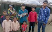  ??  ?? Leeladhar Kushwaha and wife Sukh Devi with the abandoned baby girl and their seven sons outside their house in Saimar Ka Pura village in Rajasthan’s Dholpur district