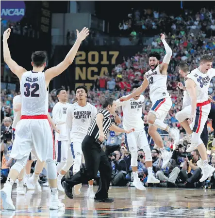  ?? TOM PENNINGTON/GETTY IMAGES ?? Gonzaga Bulldogs teammates celebrate after defeating the South Carolina Gamecocks in the NCAA men’s Final Four semifinal on Saturday at University of Phoenix Stadium in Glendale, Ariz. Gonzaga will face the North Carolina Tar Heels on Monday.