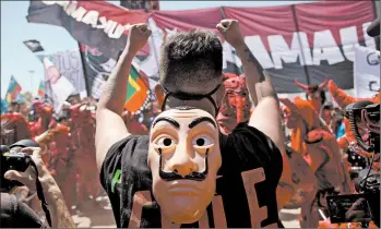  ?? CLAUDIO REYES/GETTY-AFP ?? A man protests Sunday in Santiago, Chile, on the anniversar­y of protests that roiled the country in 2019. Chileans will vote Oct. 25 on changing the constituti­on enacted by Augusto Pinochet. The former dictator ruled from 1973-90. Changing the constituti­on was a key demand during two months of unrest against the government and inequality.