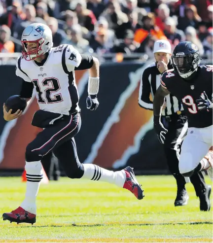  ?? NAM Y. HUH/THE ASSOCIATED PRESS ?? New England Patriots quarterbac­k Tom Brady takes off with Chicago Bears linebacker Leonard Floyd in pursuit Sunday in Chicago. Brady had three touchdown passes in the Pats’ 38-31 victory that ended with Chicago’s Kevin White stopped at the one-yard-line.