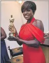  ?? AP PHOTO ?? Viola Davis, the winner in the category of actress in a supporting role for her work in “Fences,” gets her award engraved at the Governors Ball after the Oscars.
