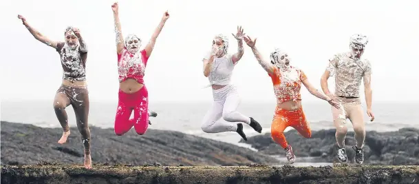  ?? Pictures: Mhairi Edwards. ?? Leap of froth: AnnaRuth Cockerham, 17, Annie Layhe, 18, Mathilde Roze, 17, Jenny Prosser, 18, and Hugo Caras, 19, jump into the sea to clean off after the foam party.