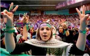  ?? AFP ?? A supporter of President Hasan Rohani makes the victory sign at a campaign rally in Tehran. —