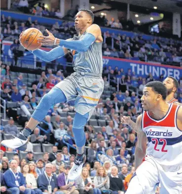  ?? [PHOTO BY BRYAN TERRY, THE OKLAHOMAN] ?? Oklahoma City’s Russell Westbrook goes to the basket past Washington’s Otto Porter Jr. during Thursday’s game at Chesapeake Energy Arena in Oklahoma City.