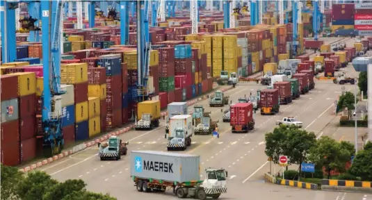  ?? ?? ▲ Lines of trucks are seen at a container terminal of Ningbo Zhoushan port in Zhejiang province, China, August 15, 2021
