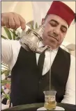  ?? Los Angeles Times/DUNE LORENZ ?? Rashid, a fez-topped waiter, pours sweet mint tea after dinner at Rick’s Cafe in Casablanca.