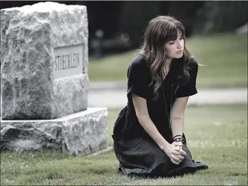  ?? Irfan Khan Los Angeles Times ?? KAYLA STOECKLEIN visits Oak Park Cemetery in Claremont, where her husband, Andrew, is buried. Andrew, a church pastor in Chino, had openly struggled with depression. He died by suicide in August.