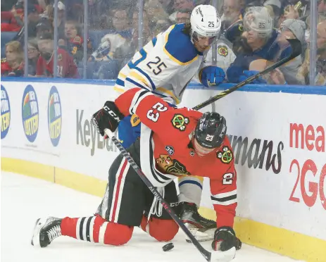  ?? JOSHUA BESSEX/AP ?? Philipp Kurashev (23) works to keep the puck away from Buffalo Sabres defenseman Owen Power (25).