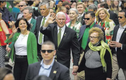  ?? Stephen B. Morton The Associated Press ?? Vice President Mike Pence, center, his wife, Karen, left, and his mother, Nancy Pence Fritch march Saturday in the St. Patrick’s Day parade in Savannah, Ga.