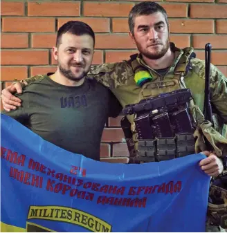  ?? ?? United front: Zelensky, left, posed for a photo with a soldier on Sunday
