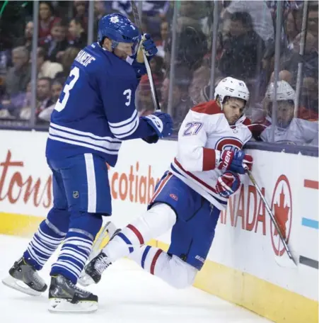  ?? LUCAS OLENIUK/TORONTO STAR ?? The Maple Leafs’ Dion Phaneuf hammers Montreal’s Alex Galchenyuk into the boards, incurring a cross-checking penalty in the process.