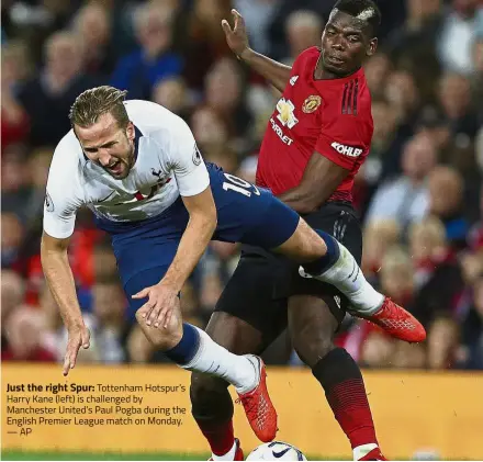  ??  ?? Just the right Spur: Tottenham Hotspur’s Harry Kane (left) is challenged by Manchester United’s Paul Pogba during the English Premier League match on Monday. — AP