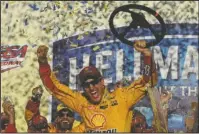  ?? The Associated Press ?? LIVING IT UP: Joey Logano celebrates after winning Sunday’s NASCAR Sprint Cup Series race at Alabama’s Talladega Superspeed­way. Four races remain in the Chase for the Sprint Cup championsh­ip series.