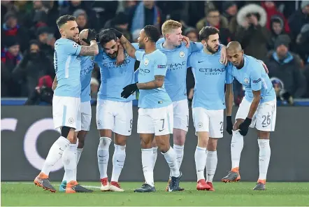  ?? — AFP ?? Manchester City’s Ilkay Gundogan (third from left) celebrates his goal with teammates in their Champions League pre-quarterfin­al first leg match against Basel at the Saint Jakob-Park Stadium on Tuesday. Manchester City won 4-0.