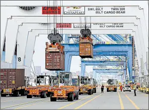  ?? AP ?? Shipping containers are unloaded at the Port of Baltimore in 2016. The United States this year has run a trade gap of $405.2 billion through September.