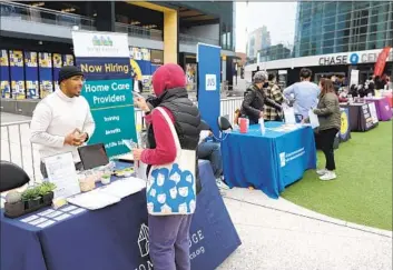  ?? Justin Sullivan Getty Images ?? A JOB SEEKER meets with a recruiter during a Healthcare Academy career and training fair in San Francisco. Healthcare and social assistance have accounted for 75% of all new jobs in California since April 2023.