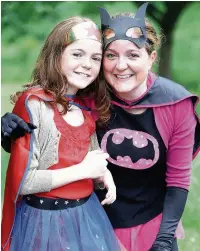  ??  ?? Junior super heroes Sophie Wood and Florence Scott, from All Saints’ School, below left, the Marple Rugby Club float and, above left, a band leads the parade