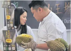  ?? REUTERS/CHINA STRINGER NETWORK ?? Promoters work at a booth of Musang King durians at the Malaysia Durian Festival in Nanning, China last year.