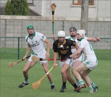  ??  ?? Adamstown’s Sean Barden looks to get free from Crossabeg-Ballymurn’s Oisin Foley.