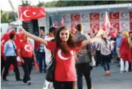  ?? — AFP ?? PATRIOTISM: A woman waves Turkish flags as Pro-Erdogan supporters gather during a rally against the military coup at Kizilay Square in Ankara, on Monday.