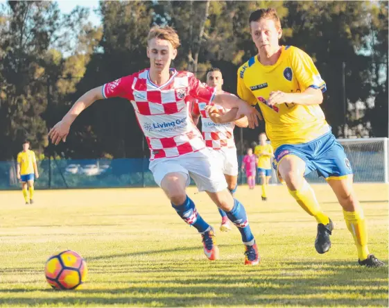  ?? Picture: MIKE BATTERHAM ?? The Gold Coast Knights’ Jaiden Walker battles Broadbeach United’s Charlie Frentz in the FFA Cup clash at Carrara.