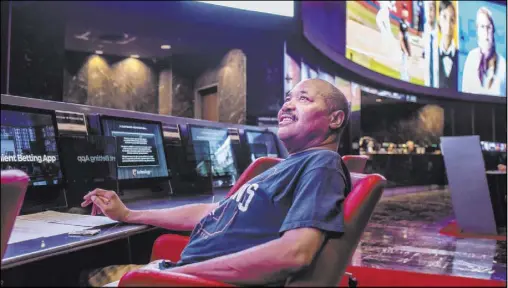  ??  ?? Al Armer bets on horse races Thursday at the Palms sportsbook, which is operated by CG Technology.