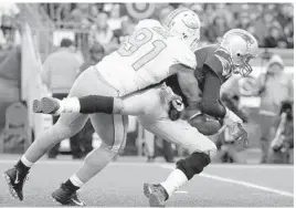  ?? STEVEN SENNE/AP ?? Miami Dolphins defensive end Cameron Wake sacks New England Patriots quarterbac­k Tom Brady during the second half their Nov. 26 game.
