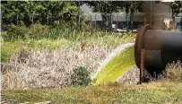  ?? PEDRO PORTAL pportal@miamiheral­d.com ?? Ccontamina­ted water from Piney Point is pumped out into Tampa Bay near Port Manatee on April 7 after a breach at the former phosphate plant.