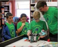  ?? CHARLES PRITCHARD - ONEIDA DAILY DISPATCH ?? Everlastin­g EV3, GenWorx Oughtamati­on, Dragon Bots of Clinton and Holy Cross Academy practice and perfect their robot designs and programmin­g as they prepare for regionals on Dec. 282017