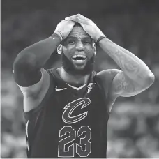  ?? EZRA SHAW/GETTY IMAGES ?? Lebron James saw a potential win turn into an overtime loss Thursday during Game 1 of the NBA Finals as Cleveland Cavaliers teammate JR Smith passed up a shot at the buzzer in the fourth quarter before the Golden State Warriors went on to win 124-114...