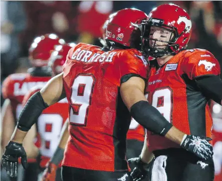  ?? JEFF MCINTOSH/ THE CANADIAN PRESS ?? Calgary Stampeders running back John Cornish and quarterbac­k Bo Levi Mitchell are gearing up for an important game against the Winnipeg Blue Bombers Friday at Investors Group Field in Winnipeg.