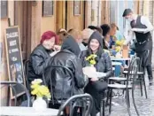  ?? GREGORIO BORGIA/AP ?? People gather for a bite to eat Sunday in Rome. Italy relaxed some COVID-19 restrictio­ns Sunday.