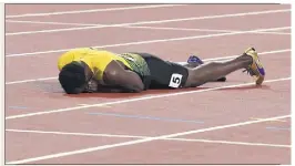  ?? (Photo AFP) ?? Terrible image que de voir Usain Bolt à terre pour sa dernière.
