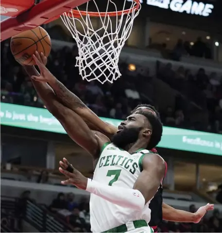  ?? Ap ?? BROWN AND WHITE ISSUE: Jaylen Brown drives to the basket against Chicago guard Coby White during the Celtics’ 117-94 win over the Bulls in Chicago last night.