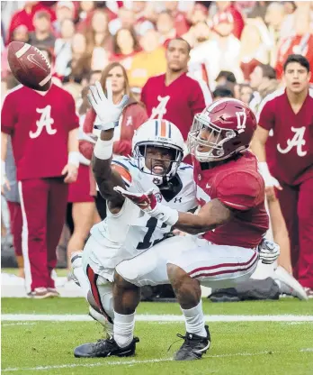  ?? AP FILE ?? Auburn’s Javaris Davis defends against Alabama wide receiver Jaylen Waddle during the Iron Bowl in 2018.