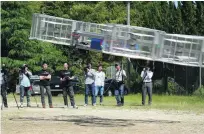  ?? Koji Ueda / AP Photo ?? Toyota team members watch the test model of the flying car take flight in central Japan yesterday.